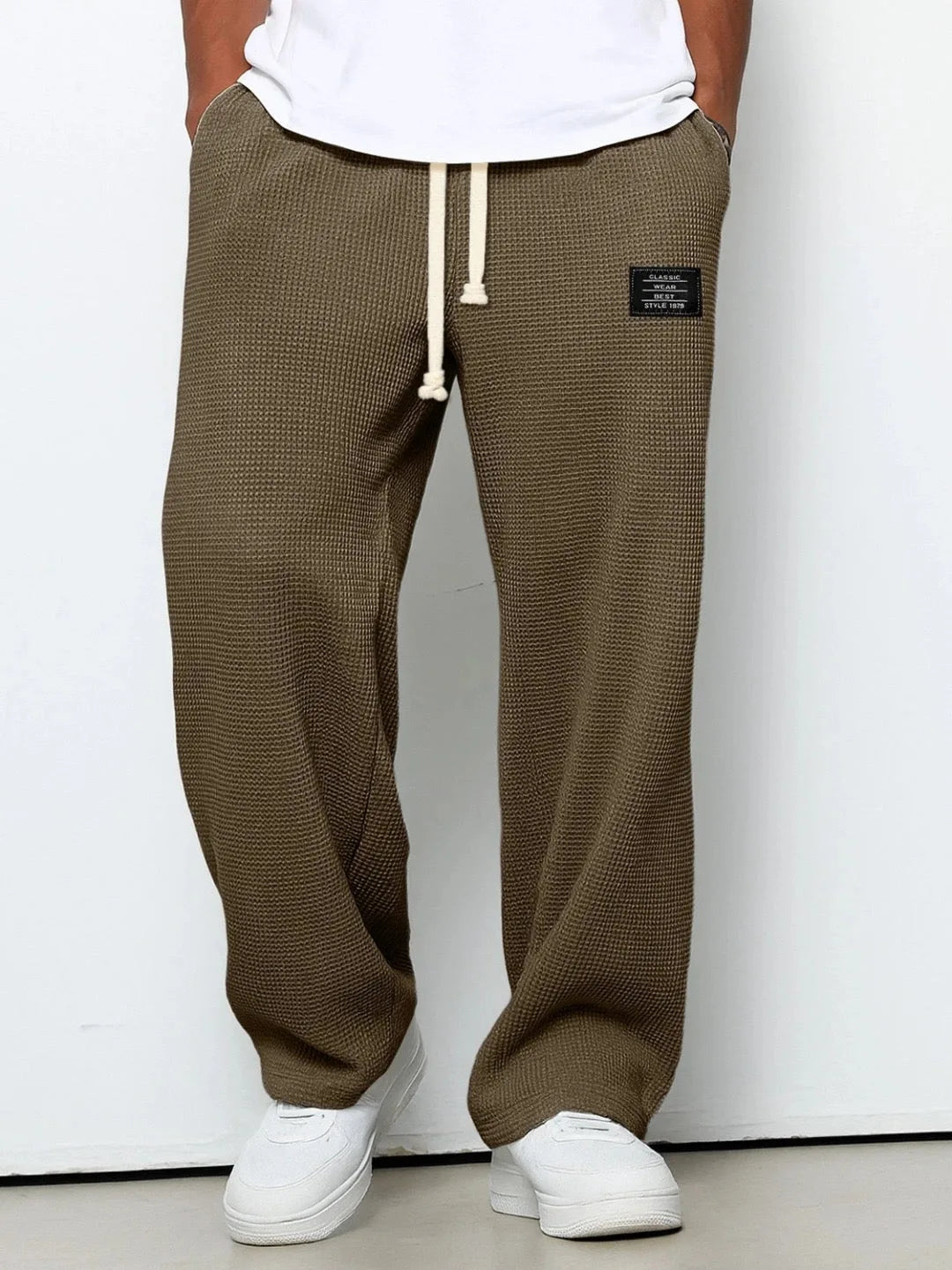 Sky blue waffle-knit pants styled with white t-shirt and white sneakers, full length front view
