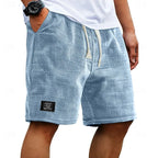 Light blue waffle-knit shorts on a model, side view showing breathable textured fabric and cream drawstring