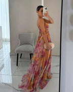 Side profile mirror shot showing the cut-out waist and wrap tie detail of the multicolour maxi dress