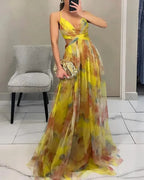 Mirror selfie showing the V-neck wrap bodice and cut-out waist of the yellow floral maxi dress