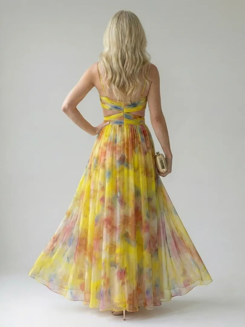 Back view of the yellow multicolour maxi dress showing the crossed waist straps and open back detail