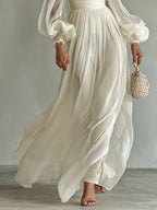 Close-up of the flowing chiffon skirt panels and gathered waistband, showing the dress falling to ankle length