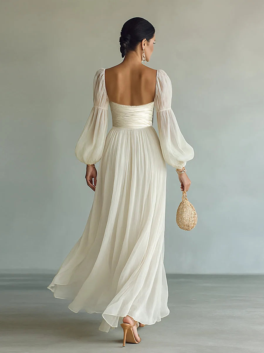 Back view of the white chiffon maxi dress showing the low square back, ruched waistband and sheer bishop sleeves
