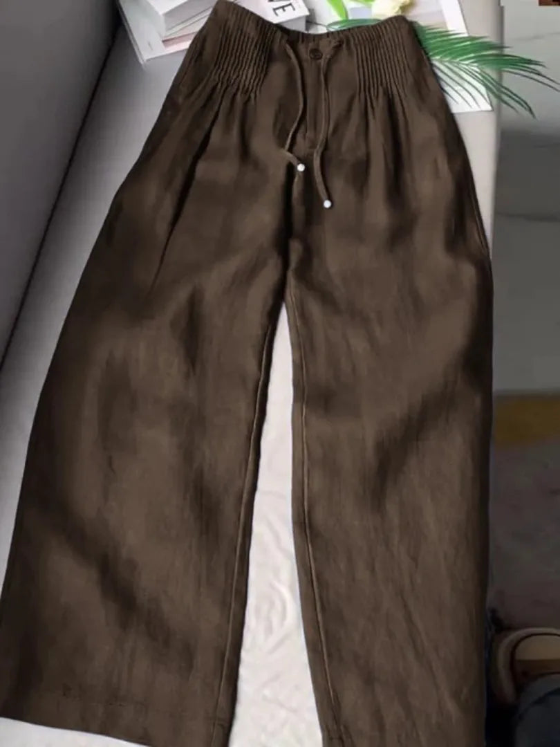 Coffee brown wide-leg pants with pintuck waistband and drawstring tie, laid flat