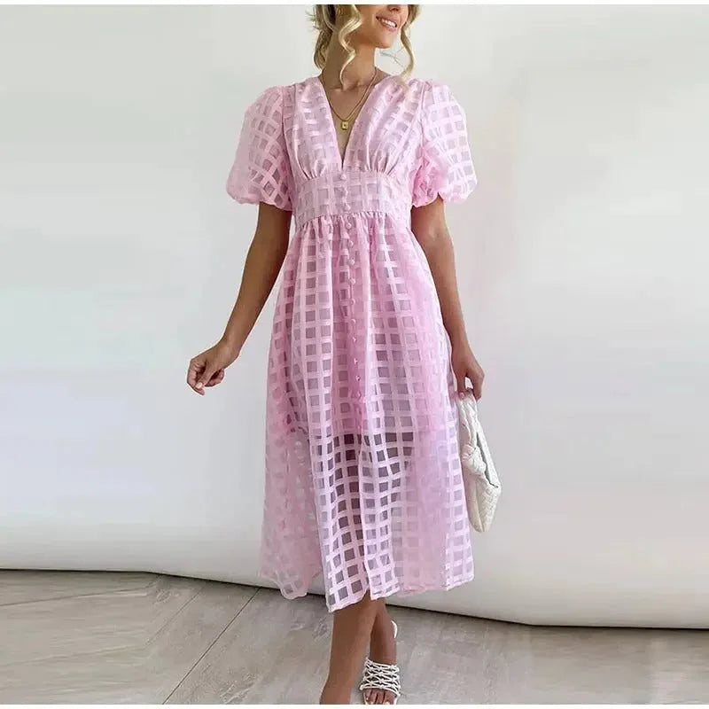 Baby pink windowpane-check midi dress with puff sleeves, V-neckline and flowing button-front skirt, shown on a model.