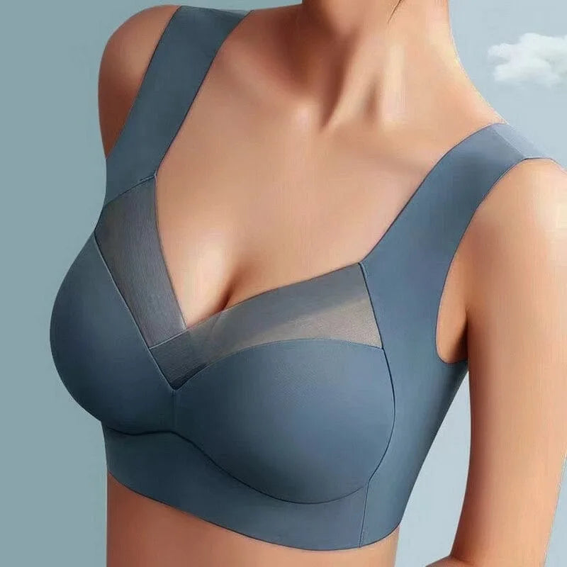 Close-up front view of a dusty blue wireless bra with V-neckline mesh panel and wide comfort straps