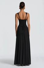 Back view of the black maxi dress showing adjustable straps and a lace-up corset-style back closure