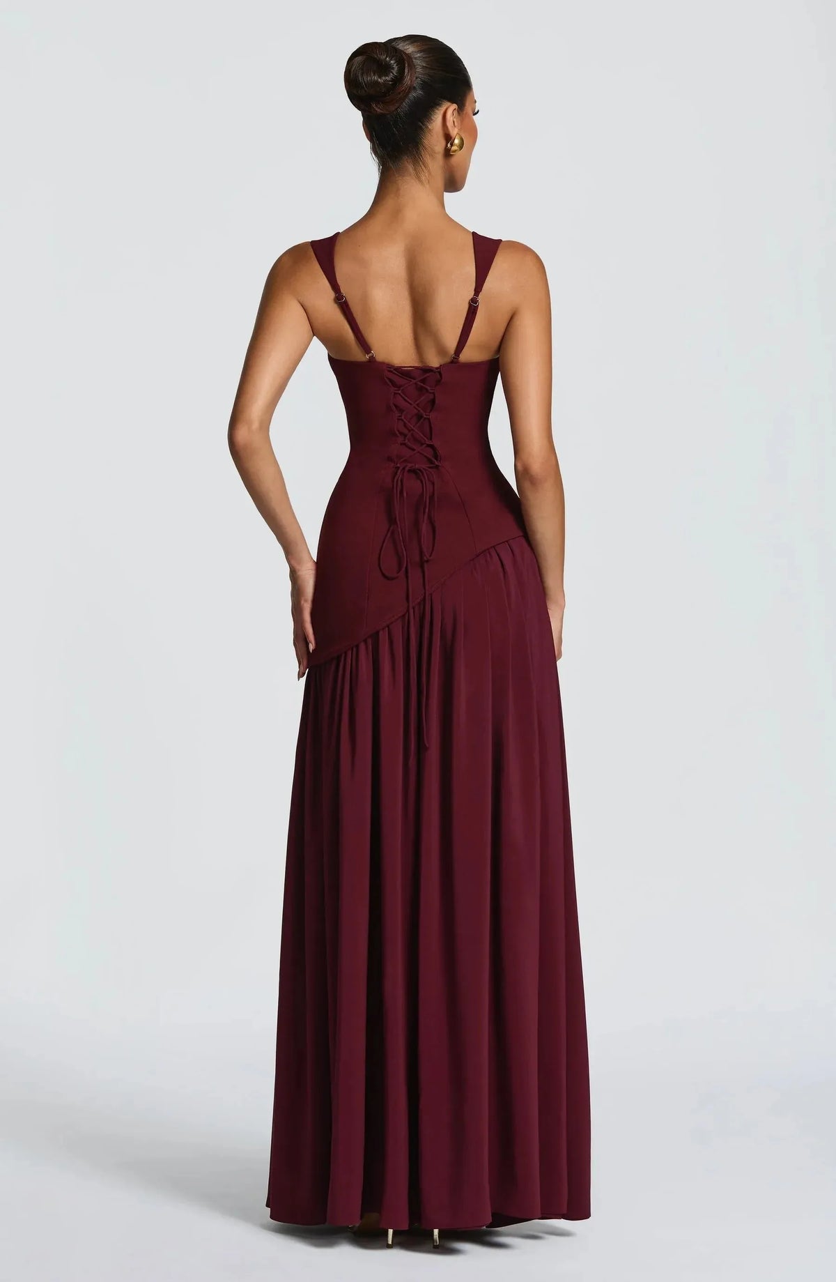 Back view of the burgundy maxi dress showing the lace-up bodice back and softly gathered floor-length skirt