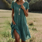 Green polka dot midi dress with round neckline, flutter short sleeves and a relaxed A-line fit