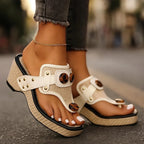 Ivory white wedge sandal with woven platform sole and tortoiseshell button on toe-post strap