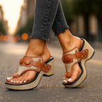 Side angle of ivory white wedge sandals showing woven platform base and toe-loop strap construction