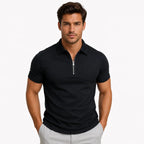 Front view of a man wearing a black zip-neck slim-fit polo shirt with silver zip pull and ribbed collar