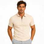 Front view of a man wearing a beige ribbed-texture zip-neck polo shirt with short sleeves