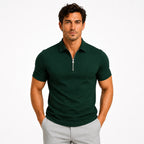 Front view of a man wearing a dark green zip-neck slim-fit polo shirt with silver zip detail